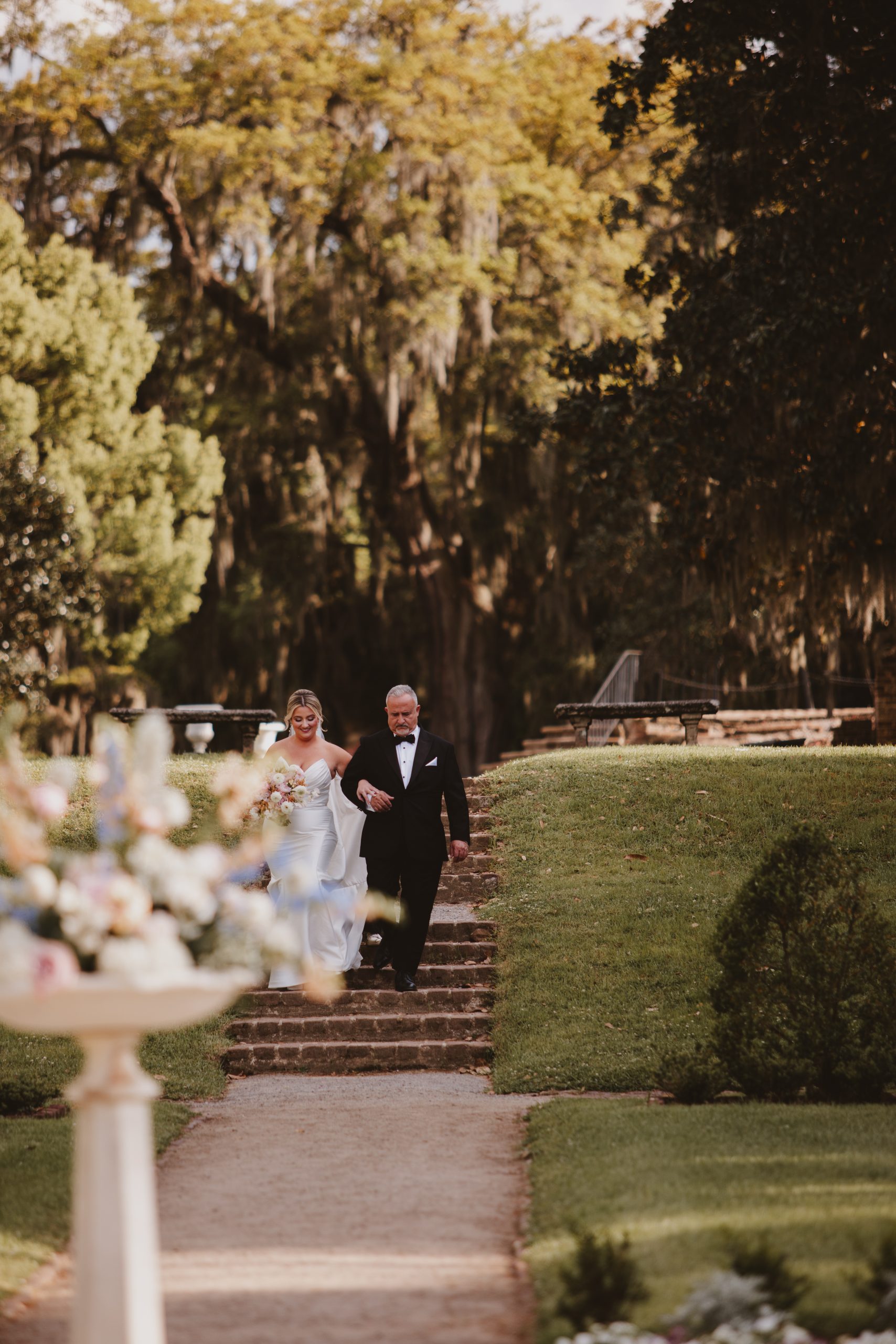 7Q6A4803 Charleston wedding photographer captures the bride walking down the aisle at this Middleton Place Wedding.