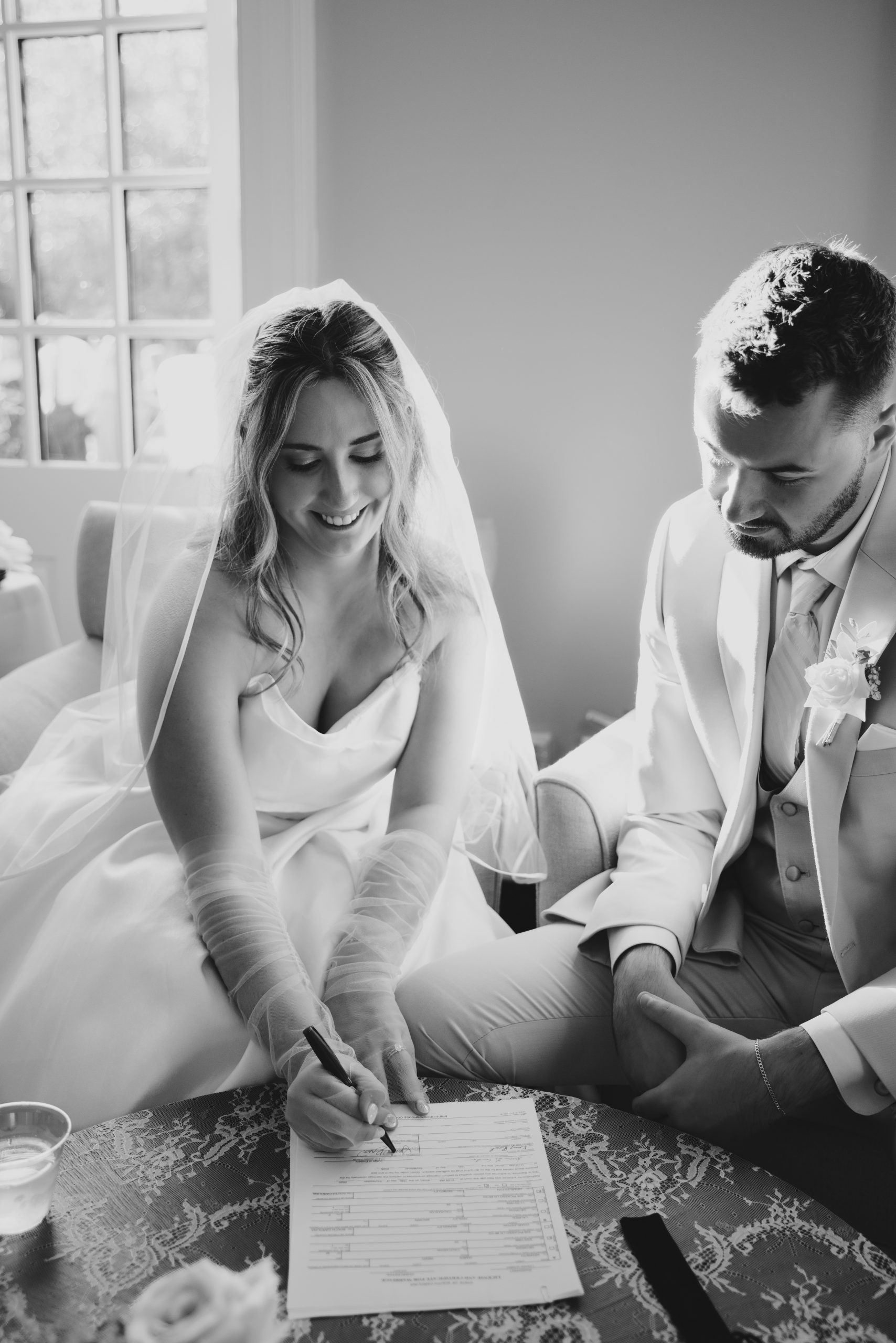 Charleston wedding photographer photographs bride signing marriage license