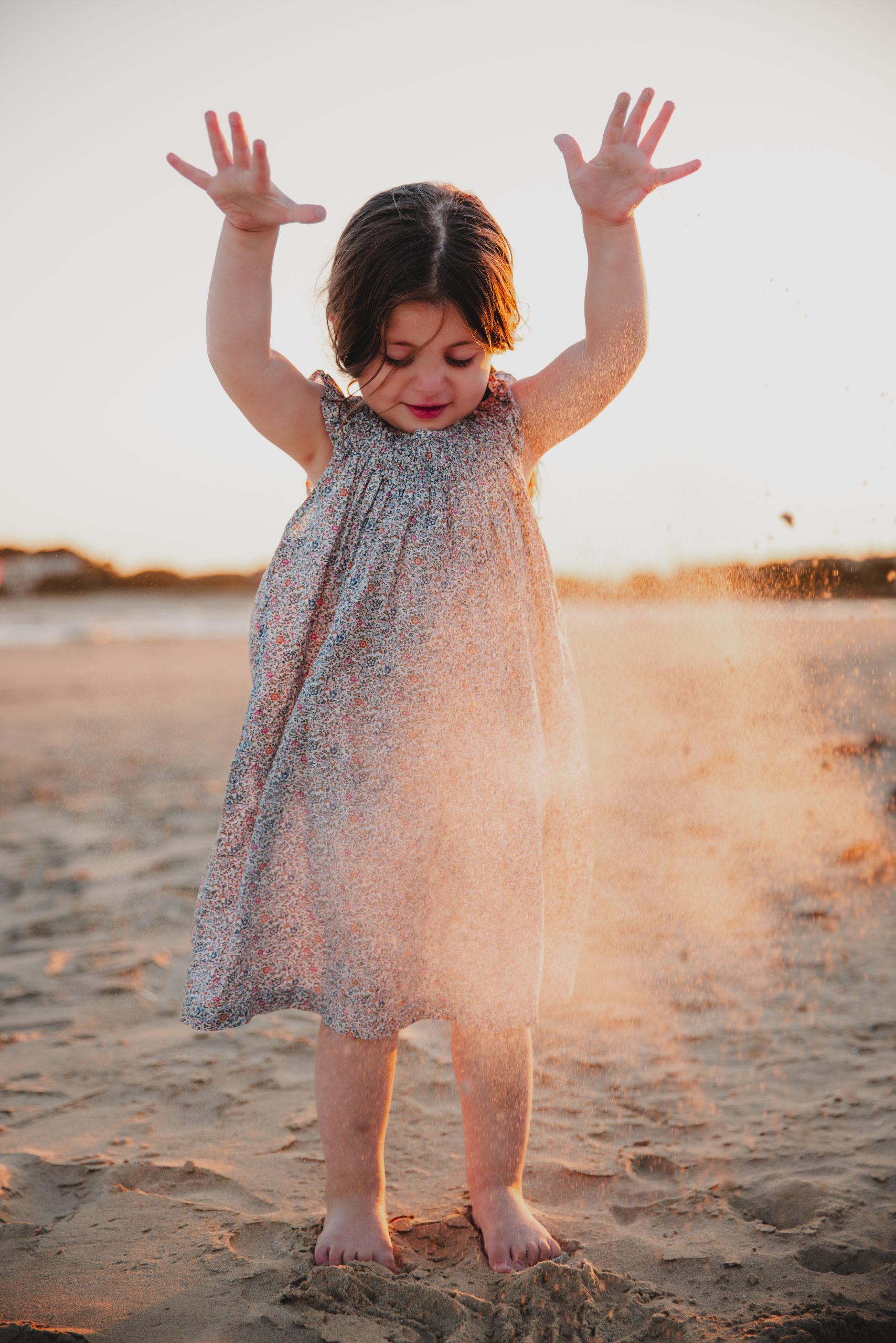 Summerville photographer captures child playing in the sand during golden hour at Isle of Palms